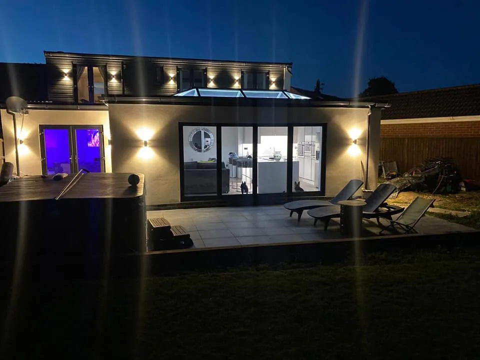 Completed contemporary rear property exterior illuminated in the evening