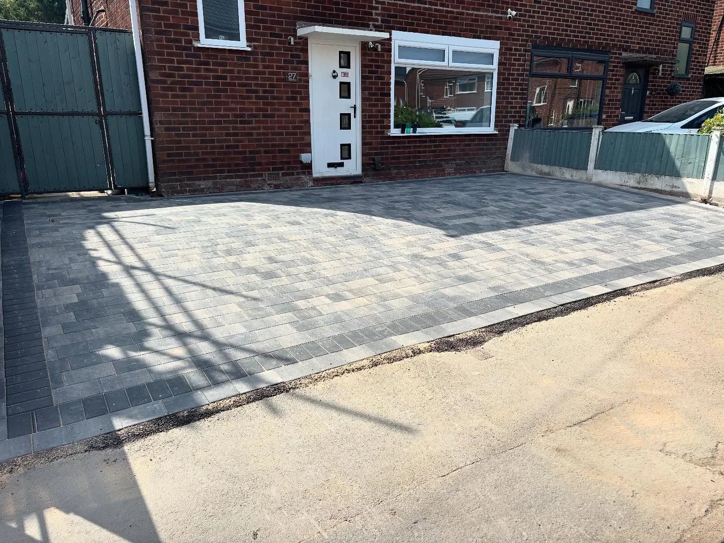 The same driveway after new grey block paving was installed