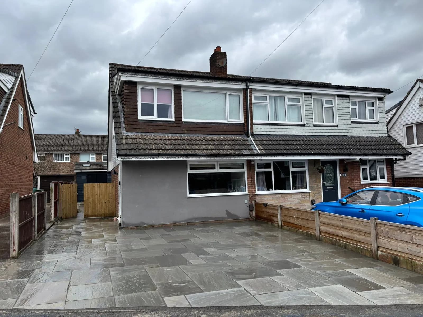 Completed grey Indian stone frontage spanning a semi-detached property