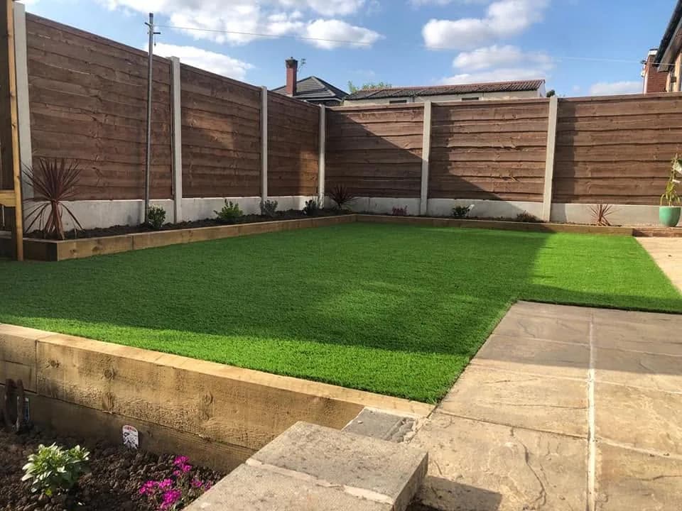 Completed garden with artificial lawn, paving and raised decking